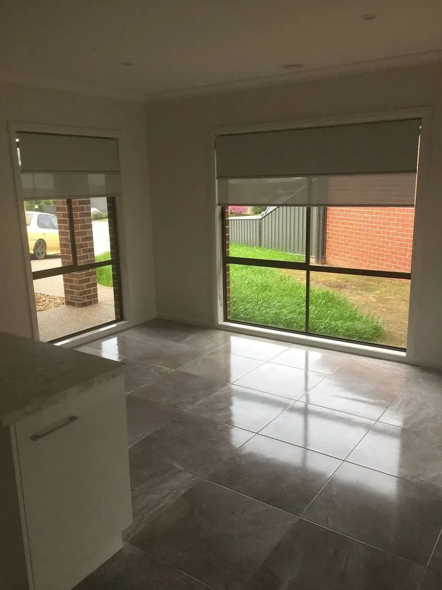 A Living Room With A Lot Of Windows And A Tiled Floor — Spring Crest Blinds, Awnings & Security Doors in Shepparton, VIC