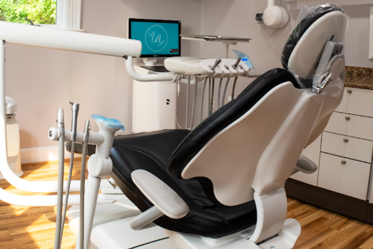 A woman is sitting in a dental chair with a toothache.