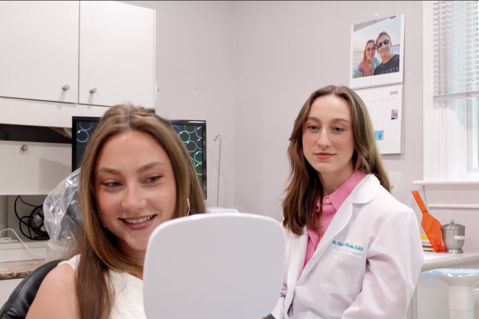 A woman is sitting in a dental chair with a toothache.