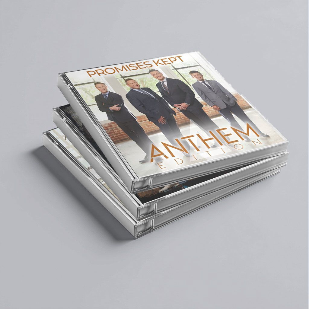 Stack of CD cases with a boy band album cover titled “Promises Kept Anthem” on a gray background