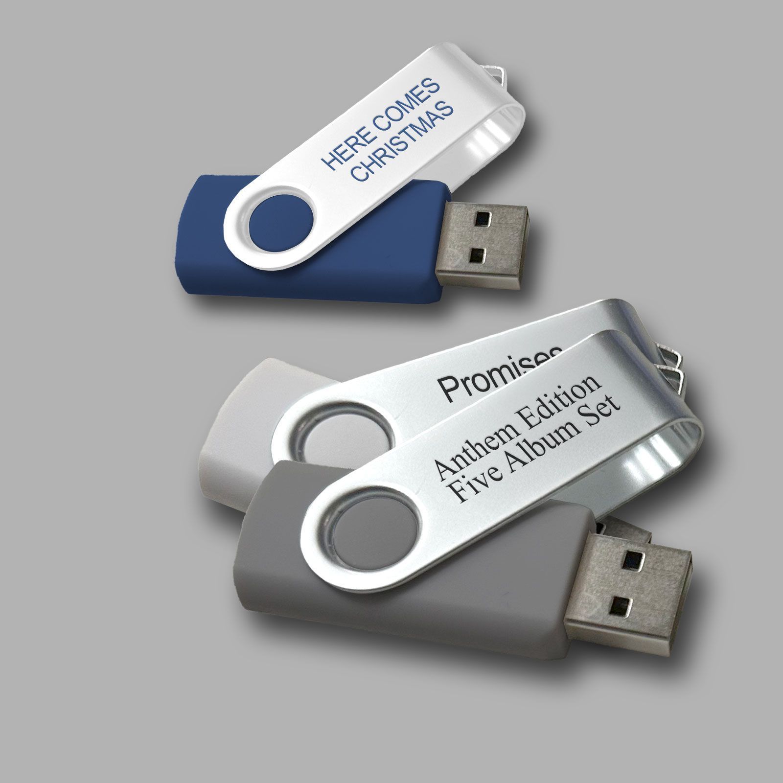Three USB flash drives with white labels reading