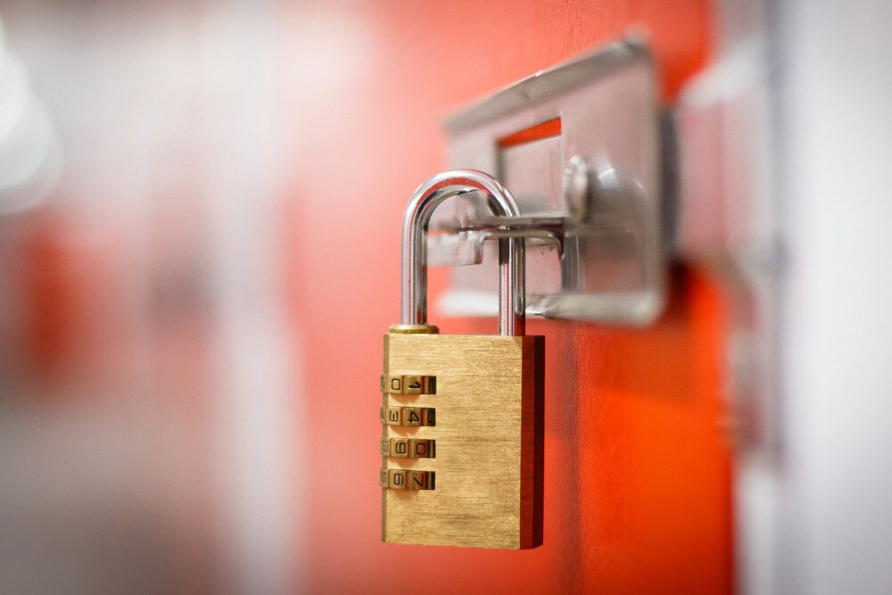 Gold Combination Padlock on an Orange Storage Unit Door — Great Ocean Locksmiths in Belmont, VIC