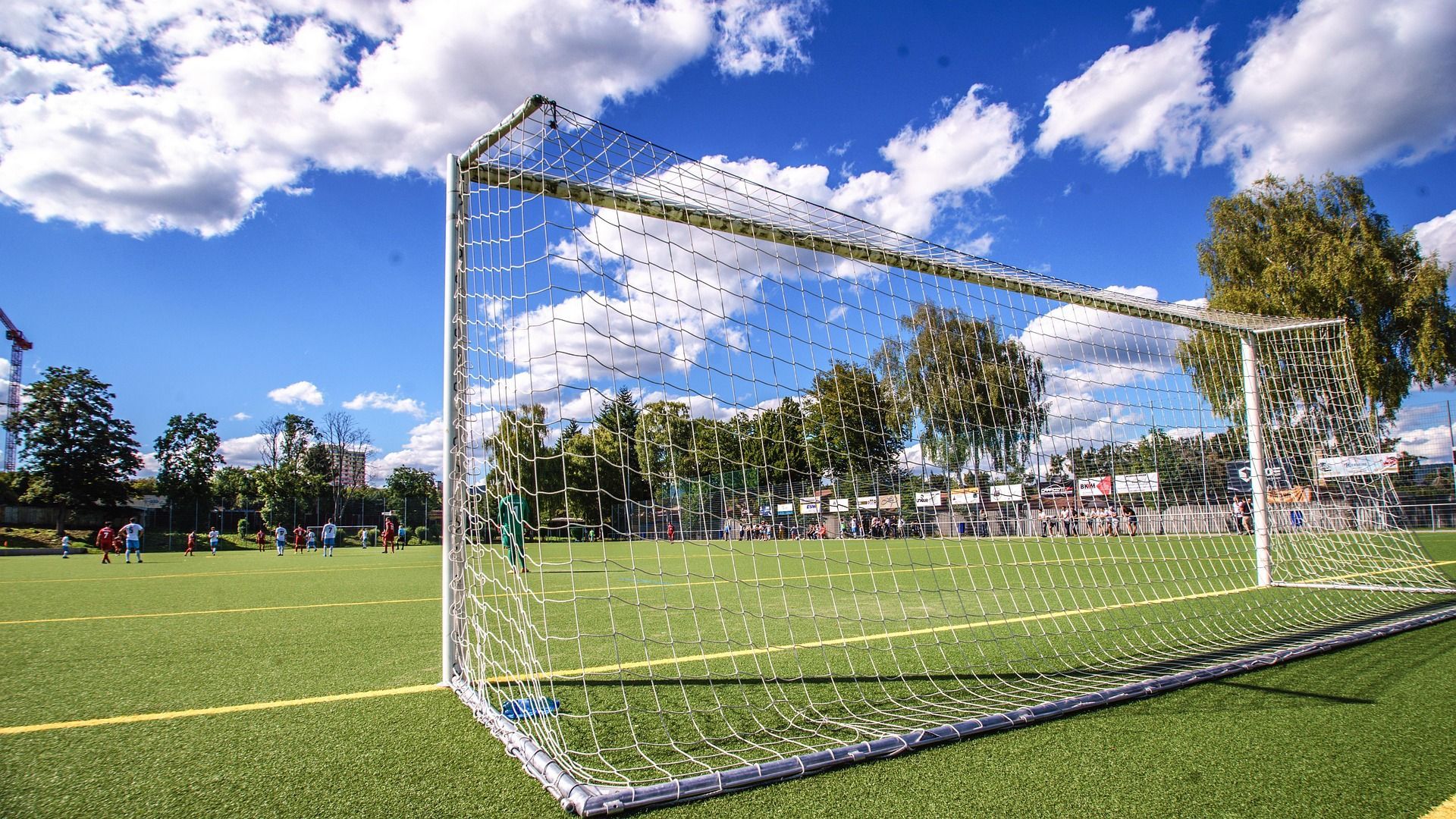 Soccer goal on artificial grass field outside during the day