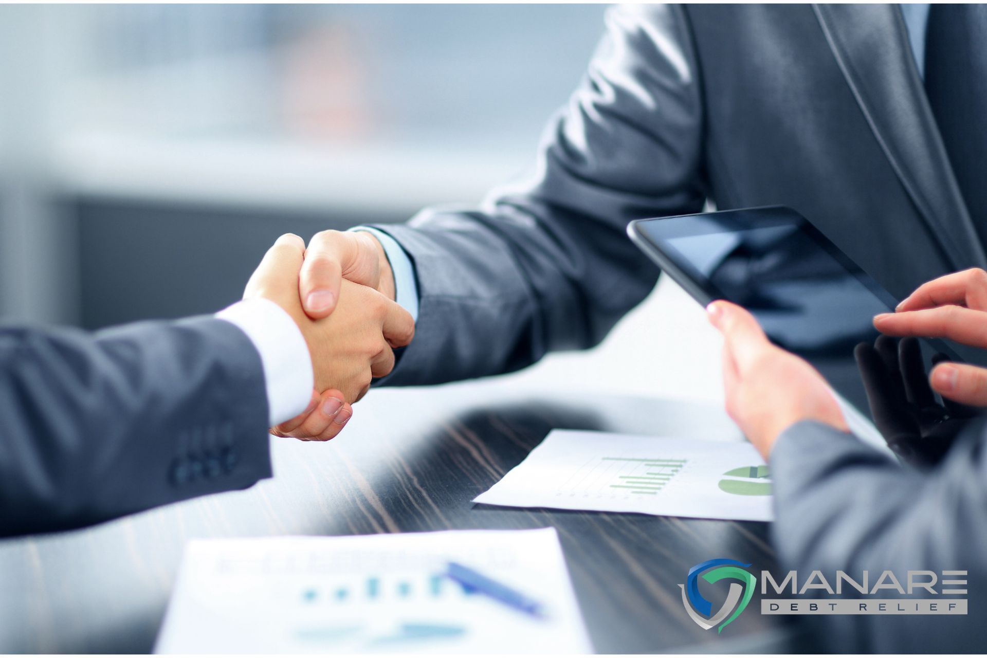 two men handshake business talking about the difference between debt consolidation and debt relief