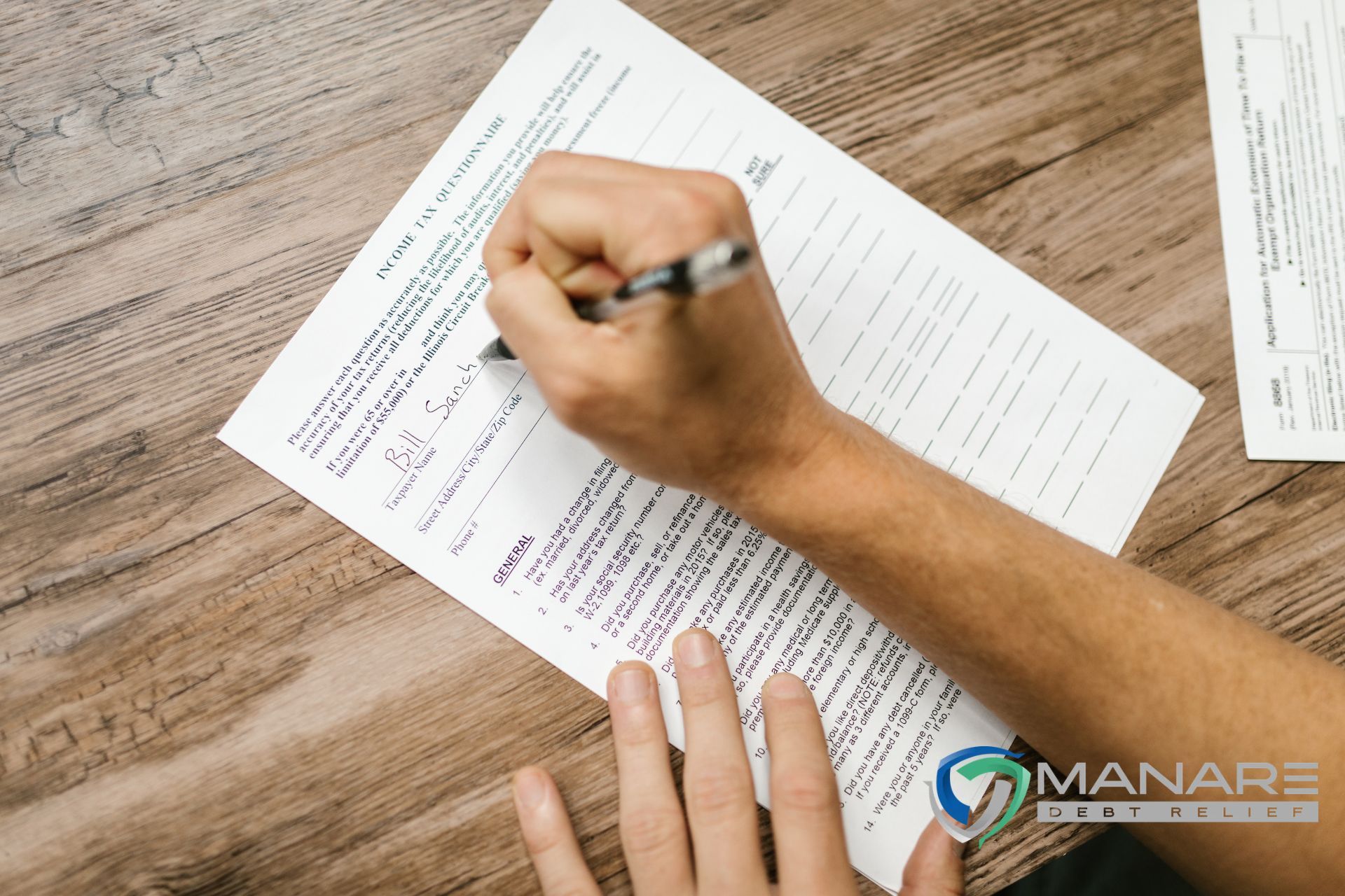 a man filling the 1099c form with manare debt relief