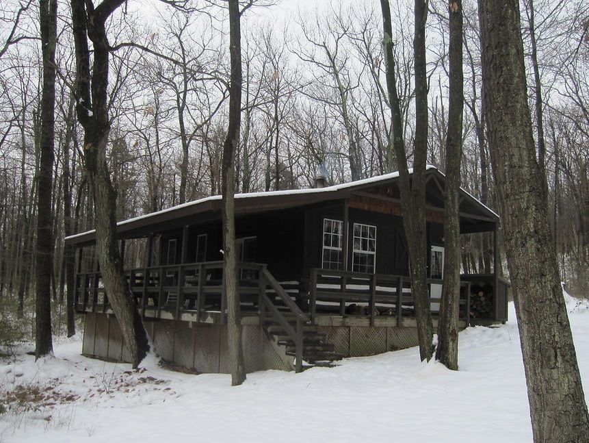 A cabin in the middle of a snowy forest