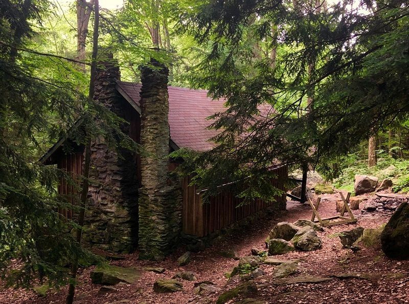 A small cabin in the middle of a snowy forest