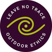 The logo for leave no trace outdoor ethics is a purple circle with a green swirl in the middle.