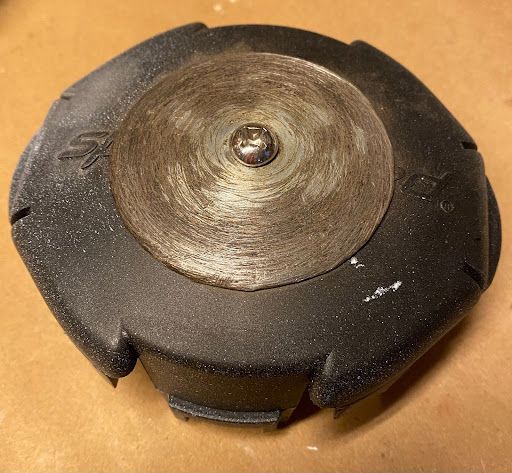 A black object with the letter s on it