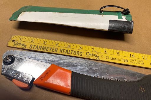 A stanmeyer realtors ruler is next to a saw