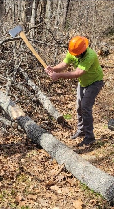 a man wearing a yellow shirt in the woods