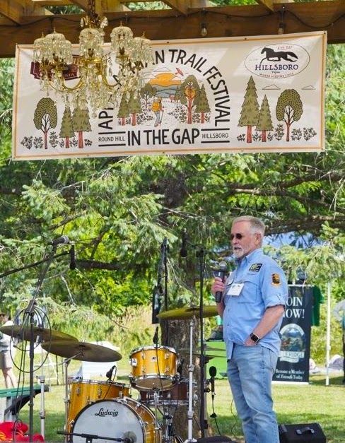 A man stands in front of a sign that says in the gap