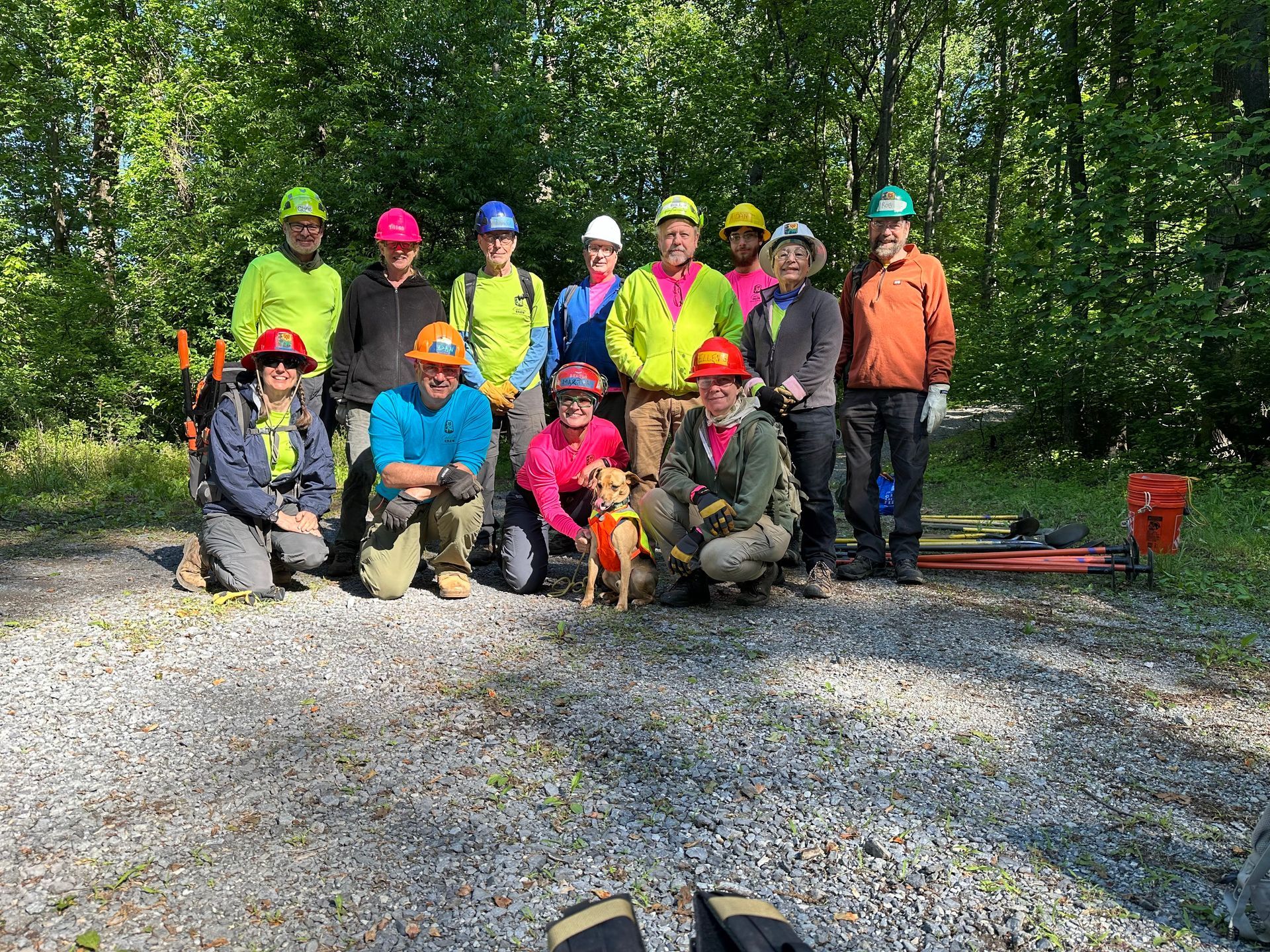 A group of people wearing hard hats are posing for a picture.