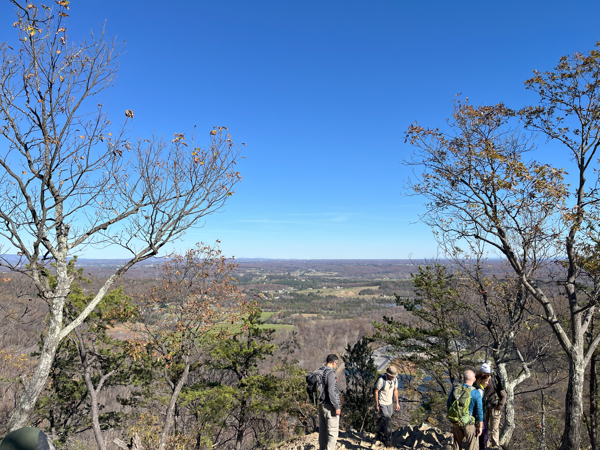 A group of people are standing on top of a mountain.