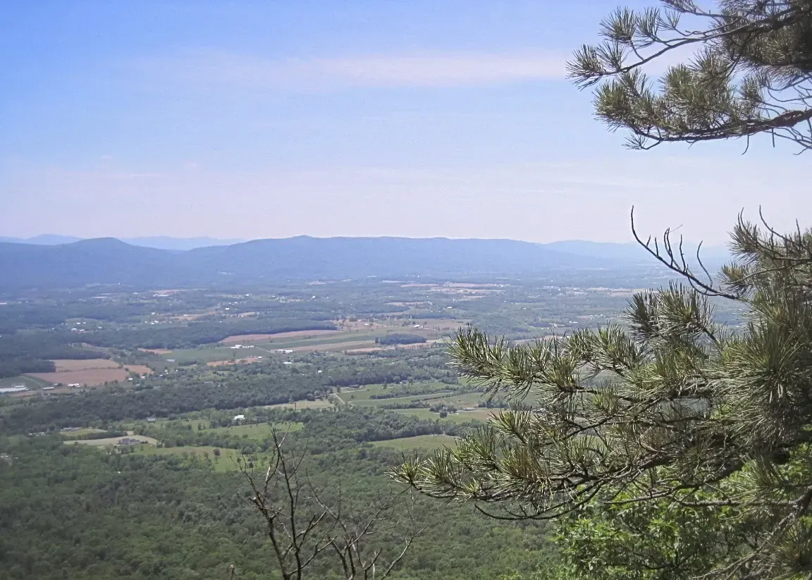 A view of a valley with mountains in the background