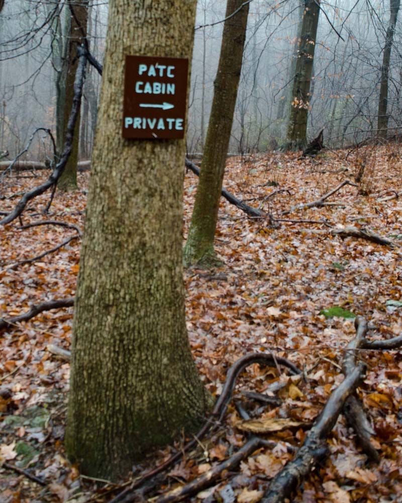 A sign on a tree says pate cabin private