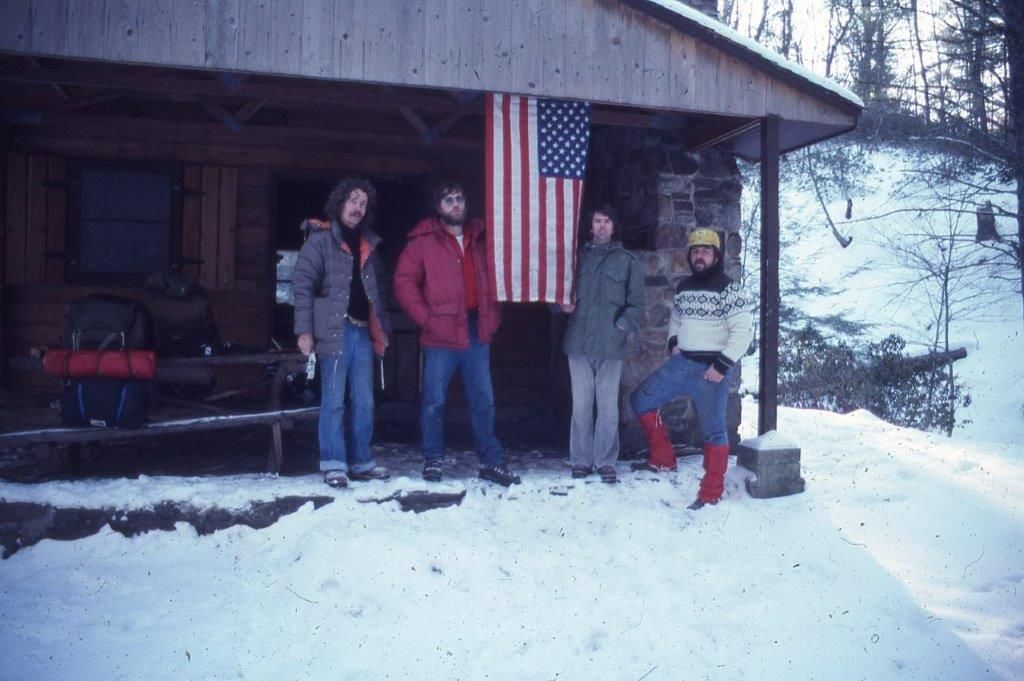 A group of people standing in front of an american flag
