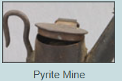 A picture of a pyrite mine with a teapot in the foreground.