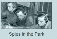 A black and white photo of three men wearing headphones with the caption spies in the park