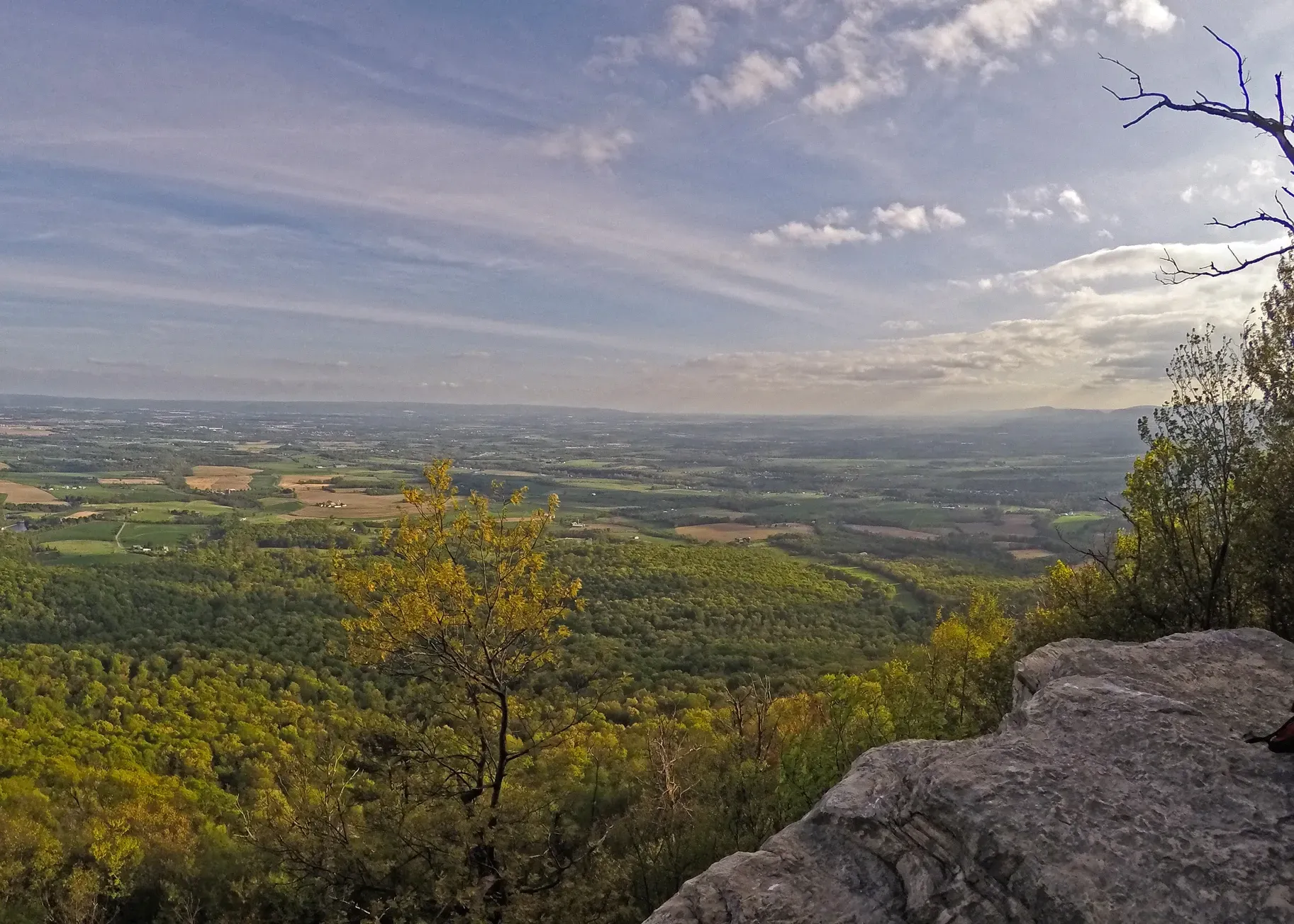 A view of a valley from the top of a mountain.