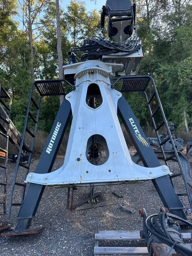 A large machine is sitting on top of a pile of gravel.