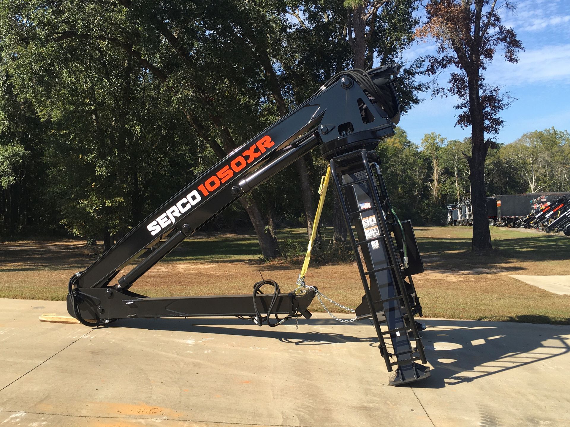 A large crane is parked on the side of the road.