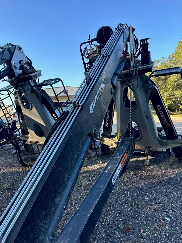 A large crane is parked on the side of the road.
