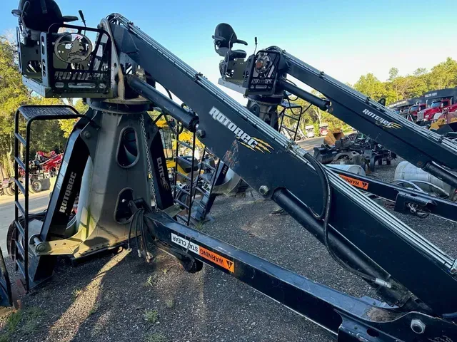 A couple of cranes are sitting next to each other in a parking lot.