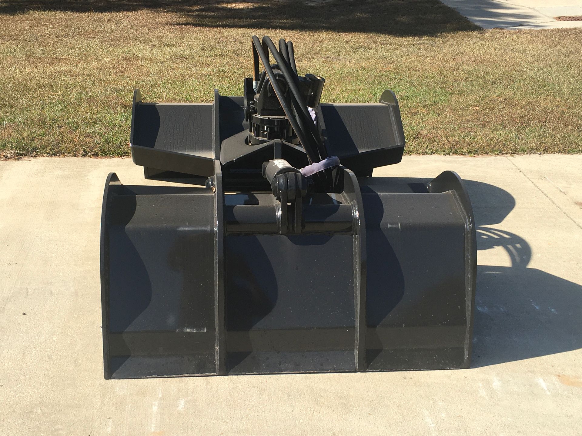 A black bucket with a crane attached to it