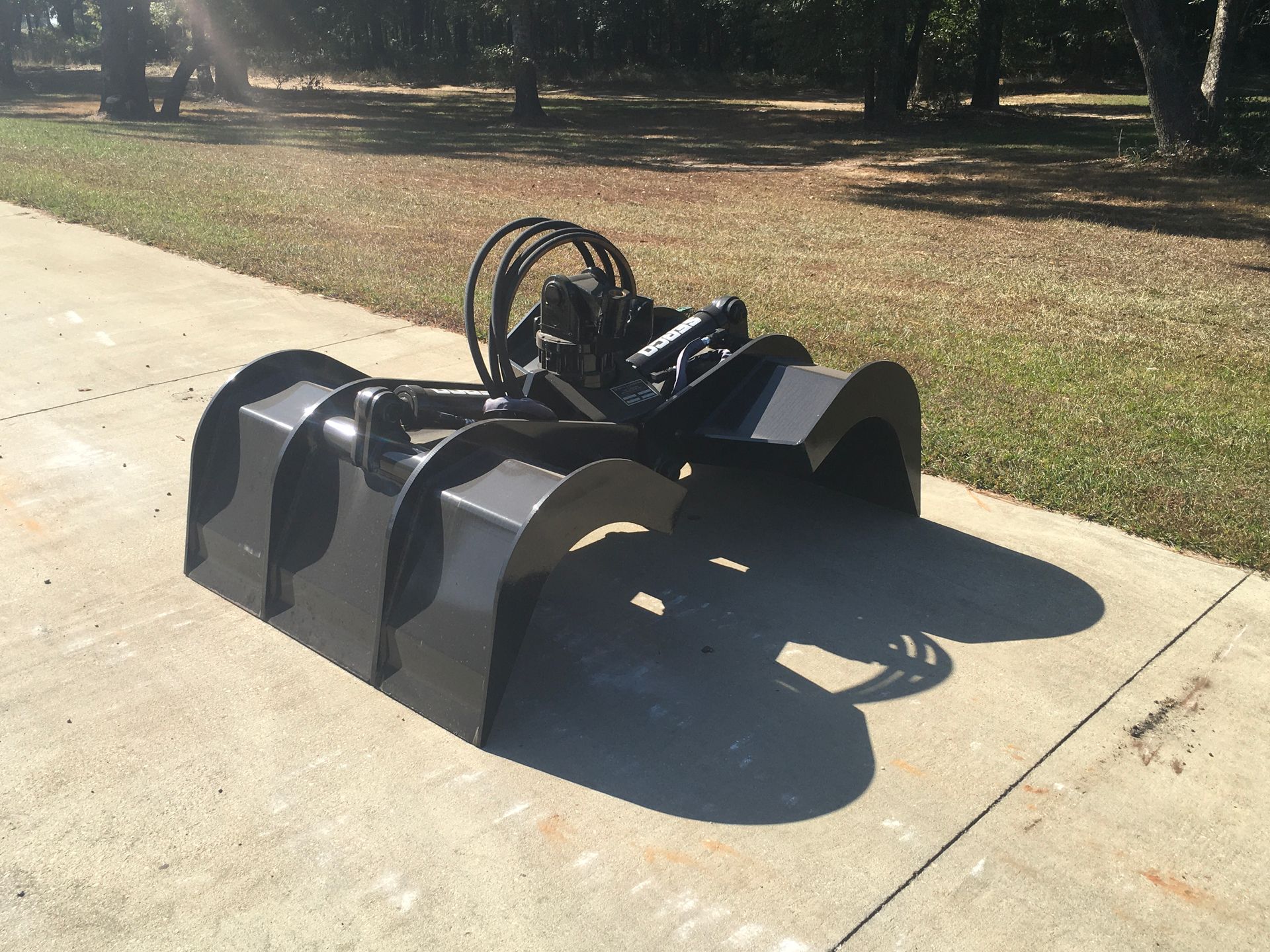 A large black bucket is sitting on a sidewalk