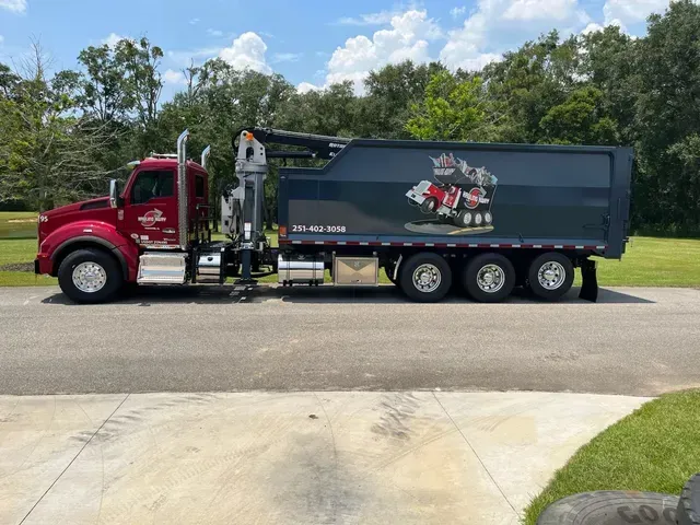 A dump truck is parked on the side of the road.