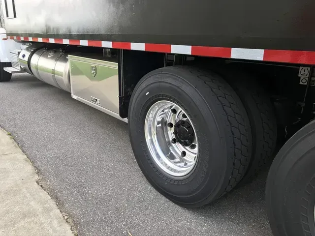 A dump truck is parked on the side of the road.
