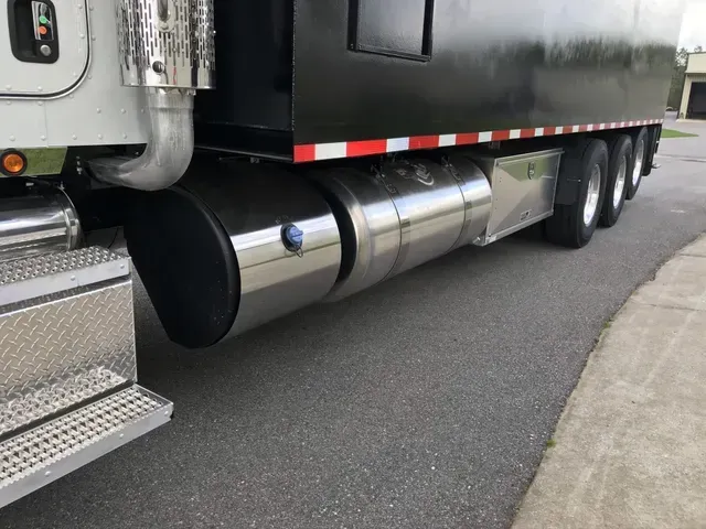 A semi truck is parked on the side of the road.