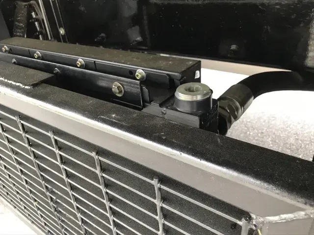 A close up of a radiator on the side of a car