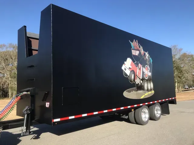 A black trailer with a picture of a truck on it