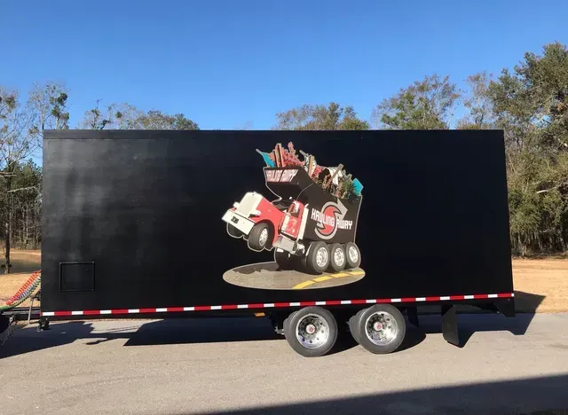 A black trailer with a picture of a race car on it