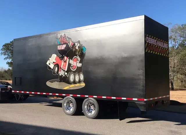 A black trailer with a picture of a truck on it