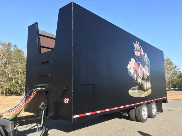 A black trailer with the number 87 on the side