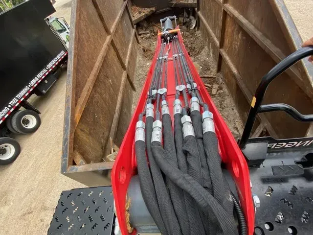 A red and black machine with hose attached to it