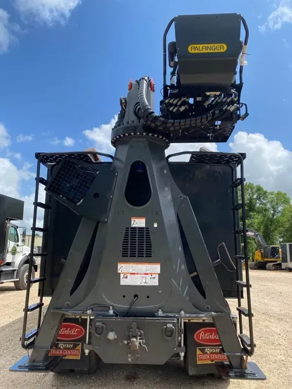 A large machine is parked in a parking lot.