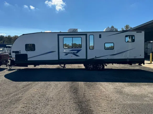 A white rv is parked in a parking lot.