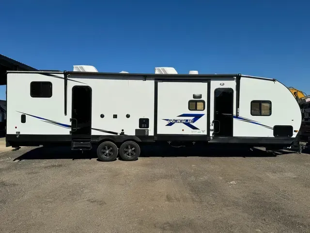 A white rv is parked in a parking lot