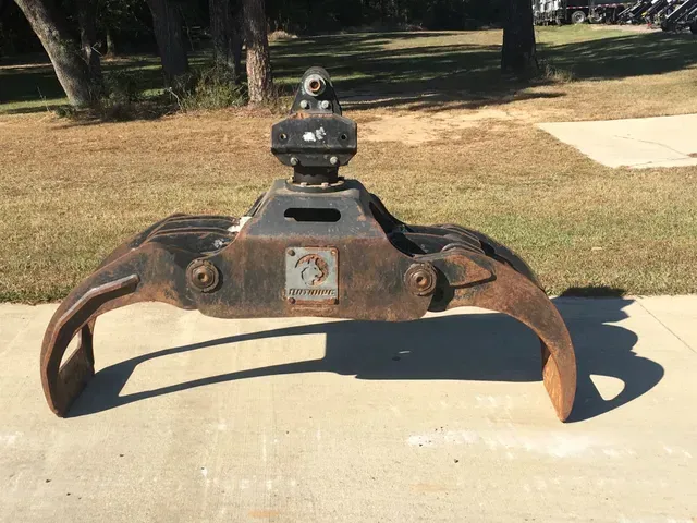 A large metal object is sitting on a sidewalk.
