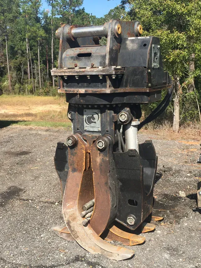 A large metal object is sitting on top of a dirt field.