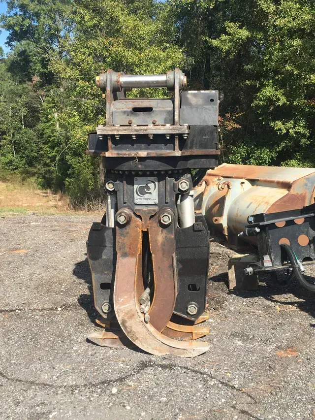 A large metal object is sitting on the ground in a parking lot.