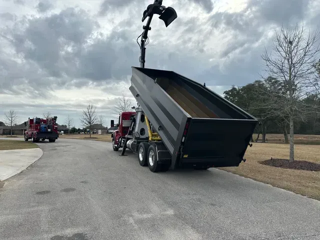 A dump truck is parked on the side of the road