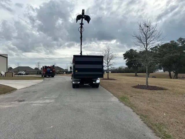 A dump truck is parked on the side of the road