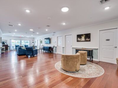 A large living room with hardwood floors and a fireplace.