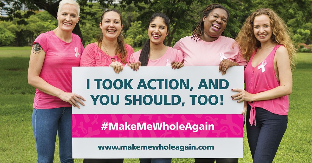 Five women in pink shirts hold a sign: 