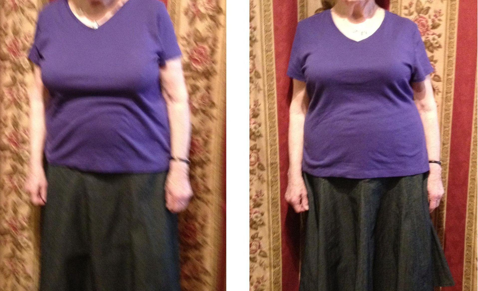 Woman in a purple shirt and long skirt, standing in front of patterned curtains.